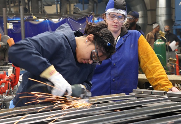 Woman in green shirt in manufacturing facility